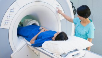 technician putting patient into MRI scanner