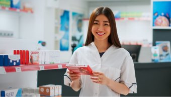 Asian employee working in pharmaceutical drugstore shop, looking at cardiology medicaments. Analyzing medical treatment and supplements in pharmacy retail store, healthcare. Handheld shot.