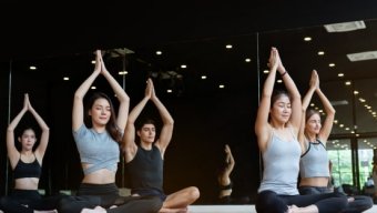 People participating in a yoga class at the gym